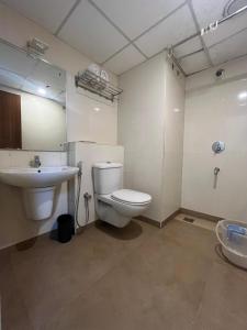a bathroom with a toilet and a sink at HOTEL DWARA in Subrahmanya +14 photos