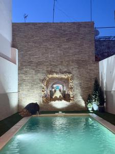 a man laying in a swimming pool in a house at Geranio Chipionahome in Chipiona