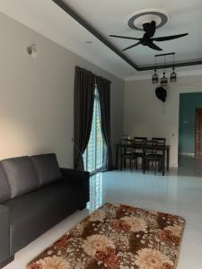 a living room with a couch and a table at Homestay kampung moden in Pendang +6 photos