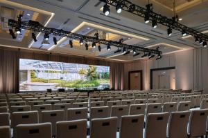 an empty lecture hall with white chairs and lights at the DOUGLAS, Autograph Collection in Vancouver
