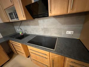 a kitchen counter with a sink and a microwave at Appartement 3 in Diemelstadt  +6 photos