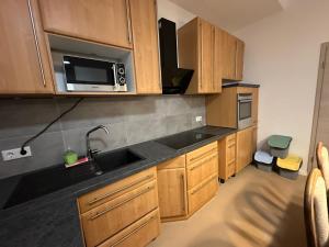 a kitchen with a sink and a microwave at Appartement 3 in Diemelstadt 
