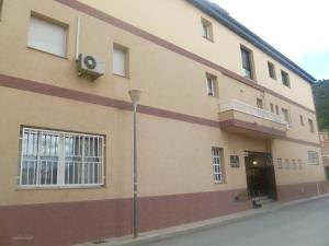 a building with a balcony on the side of it at Hotel Pepo in Benifallet