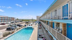a view of a hotel with a pool and a parking lot at 6701 Atlantic Ave, Unit 301 in Wildwood Crest