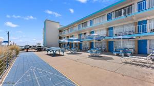 a building with tables and chairs and umbrellas at 6701 Atlantic Ave, Unit 301 in Wildwood Crest