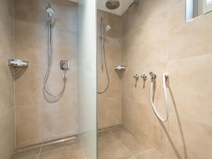 a bathroom with a shower with a glass door at Luxury Chalet in Saalbach-Hinterglemm with Sauna in Saalbach-Hinterglemm +51 photos
