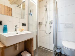 a bathroom with a sink and a shower at Luxury Chalet in Saalbach-Hinterglemm with Sauna in Saalbach-Hinterglemm