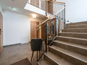 a stairway with a chair and a stair case at Luxury Chalet in Saalbach-Hinterglemm with Sauna in Saalbach-Hinterglemm