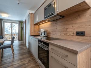 a kitchen with wooden walls and a counter top at Luxury Chalet in Saalbach-Hinterglemm with Sauna in Saalbach-Hinterglemm