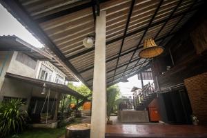 awning over a patio of a building with a pole at Hug Her Him Nan in Nan