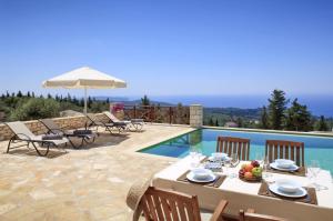 a patio with a table and chairs next to a pool at Villa Asteri in Vlachopoulátika