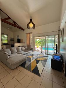 a living room with a couch and a table at Belle maison équipé avec piscine in Mamoudzou