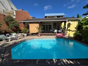 a swimming pool in front of a house at Belle maison équipé avec piscine in Mamoudzou +9 photos
