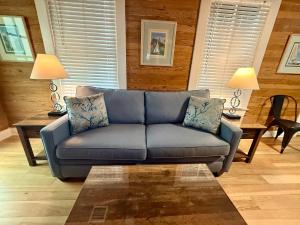 a blue couch in a living room with two lamps at Utopia Tropical Village in Key West +20 photos