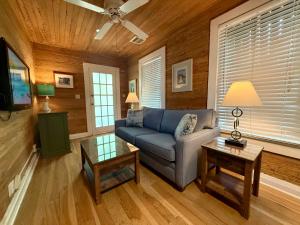 a living room with a blue couch and a table at Utopia Tropical Village in Key West