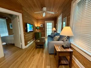 a living room with a couch and a tv at Utopia Tropical Village in Key West