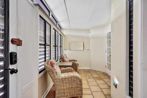 a hallway with wicker chairs and a table at Beach Club Oasis #304 in Key West
