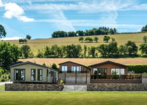 a rendering of a house with a hill in the background at Rockbridge Country Park in Presteigne