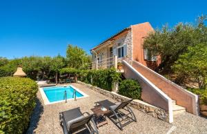 a home with a swimming pool and a house at Amalthia Cottage in Vathi