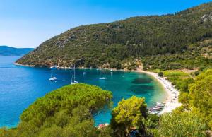 a view of a beach with boats in the water at Amalthia Cottage in Vathi +8 photos