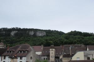 a group of buildings in front of a mountain at POLIGNY, appartement centre ville in Poligny