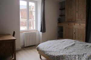 a bedroom with a bed and a window at POLIGNY, appartement centre ville in Poligny