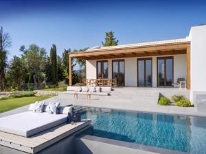 a villa with a swimming pool and a house at Villa Anthilia in Syvota