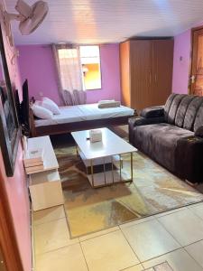 a living room with a couch and a table at Twendzetu kilifi in Kilifi