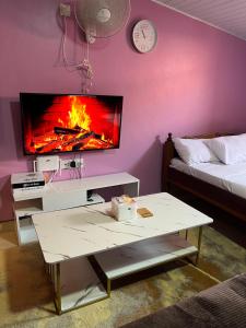 a living room with a tv and a coffee table at Twendzetu kilifi in Kilifi