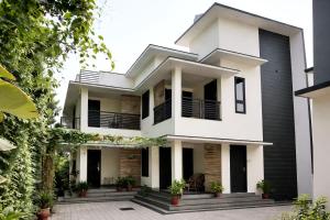 a house with black and white at Varkala Days Home Stay in Varkala