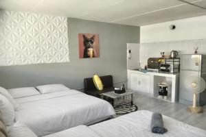 a room with two beds and a dog picture on the wall at IMPACT popular condo c5 แม่ตังค์ in Ban Bang Phang
