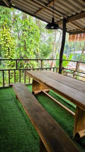 a wooden picnic table sitting on the grass at Hostel Ko Kut in Ko Kood +32 photos
