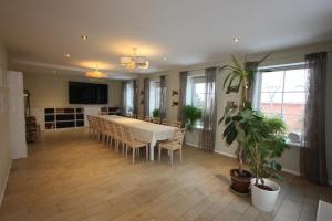 a dining room with a white table and chairs and a table at Virulase Holiday Home in Toila +25 photos