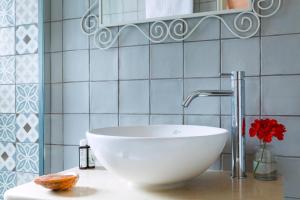 a bathroom with a white bowl sink on a counter at Olive Cottage in Petrátika +24 photos