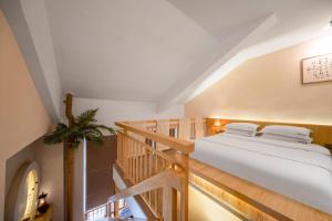 a bedroom with a bed and a staircase at Phoenix Dragon M.I.C.E Hotel in Kunming