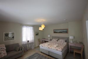 a bedroom with a bed and a couch at Virulase Holiday Home in Toila