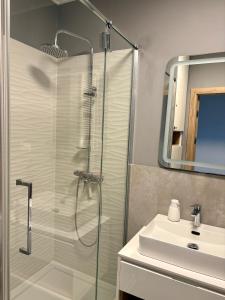 a bathroom with a shower and a sink at Apartamenty FilGood in Wałcz