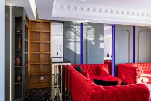 a living room with red couches in a room at New Beach Suite in Sarandë