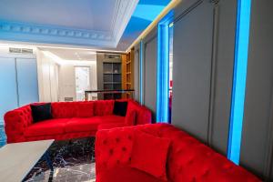 a living room with a red couch and a table at New Beach Suite in Sarandë