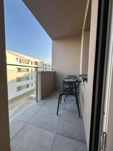 a balcony with a table and chairs on a building at Apartament w centrum 5A in Iława