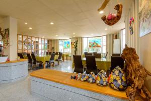 a waiting room with a table and chairs in it at Owl Castle in Hualien City