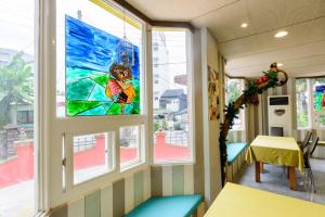 a stained glass window in a room with a table at Owl Castle in Hualien City