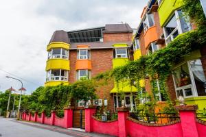 a red and yellow building on the side of a street at Owl Castle in Hualien City