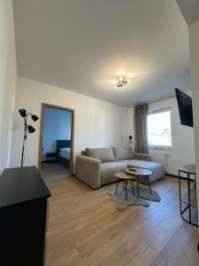 a living room with a couch and a table at Apartament w centrum 5A in Iława