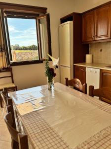 a kitchen with a table with a vase of flowers on it at Limnes Seaside Retreat in Naxos Chora +13 photos