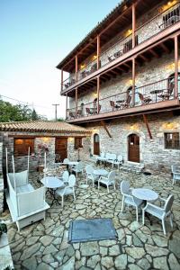 a patio with tables and chairs in front of a building at Archontiko in Andritsaina