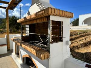 a brick oven with a roof on top of it at Limnes Seaside Retreat in Naxos Chora