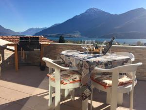 a table with a glass of wine on a balcony at Al Borgo in Gravedona