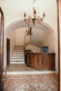 a large room with a staircase and a chandelier at Il Casino di Remartello in Loreto Aprutino +105 photos