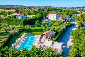 an aerial view of a resort with a pool and a river at Il Casino di Remartello in Loreto Aprutino